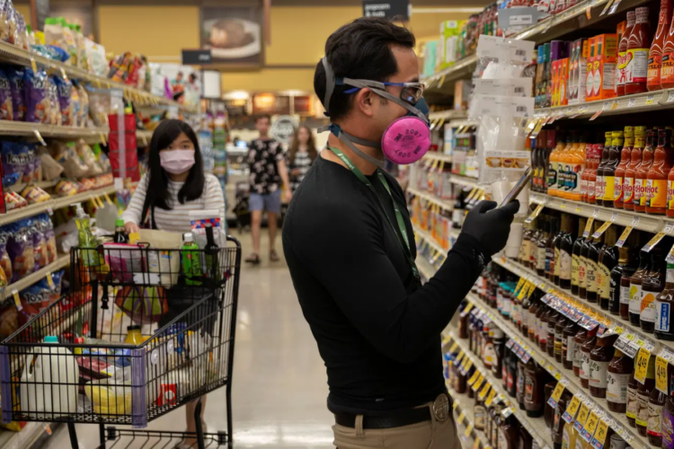 Grocery shoppers wear masks due to coronavirus